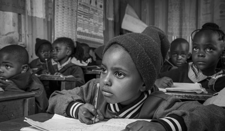 Young students engaged in classroom education for community upliftment.